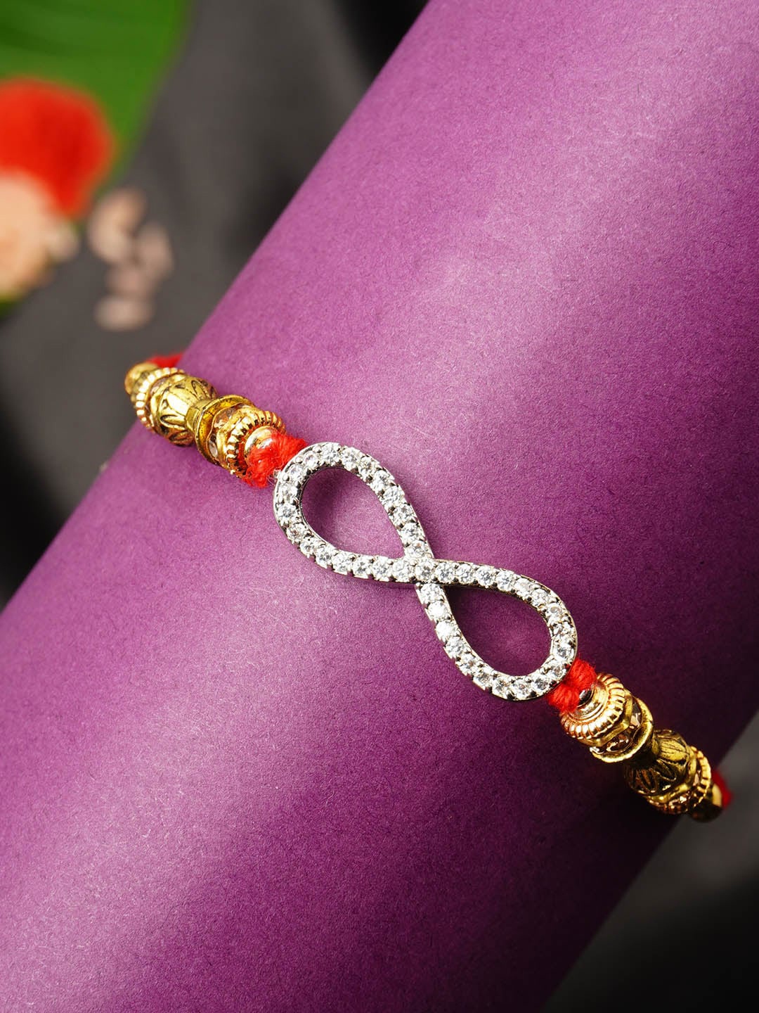 

Urmika Men Gold-Toned White Stone-Studded & Beaded Rakhi