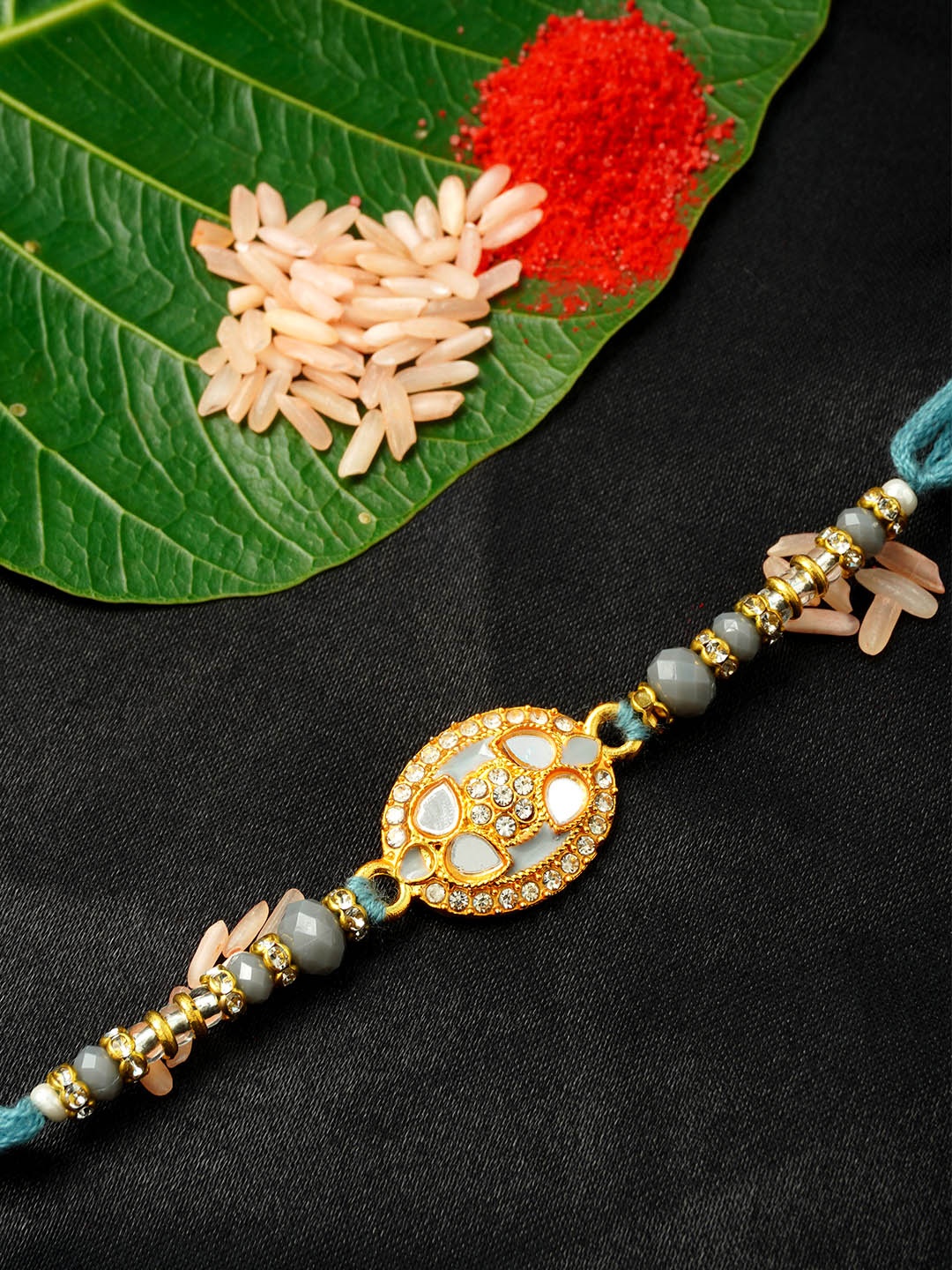 

Urmika Men Gold-Toned & Grey Crystal Studded Rakhi & Roli Chawal