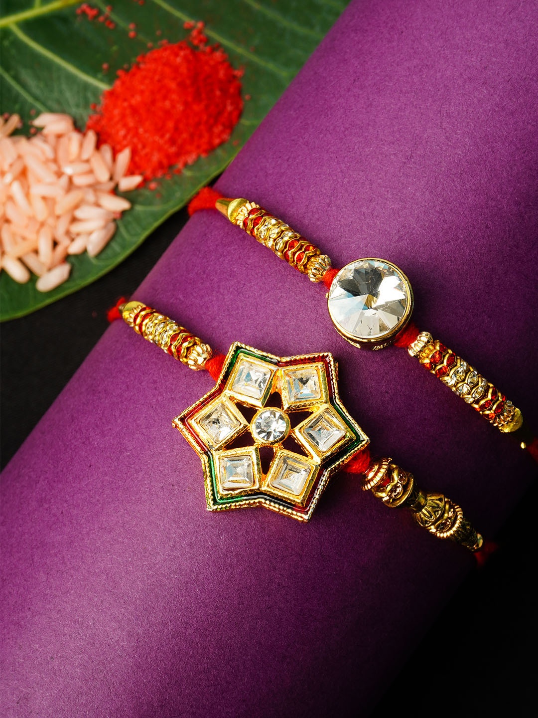 

Urmika Set Of 2 Stone Studded Rakhis With Roli Chawal, Gold