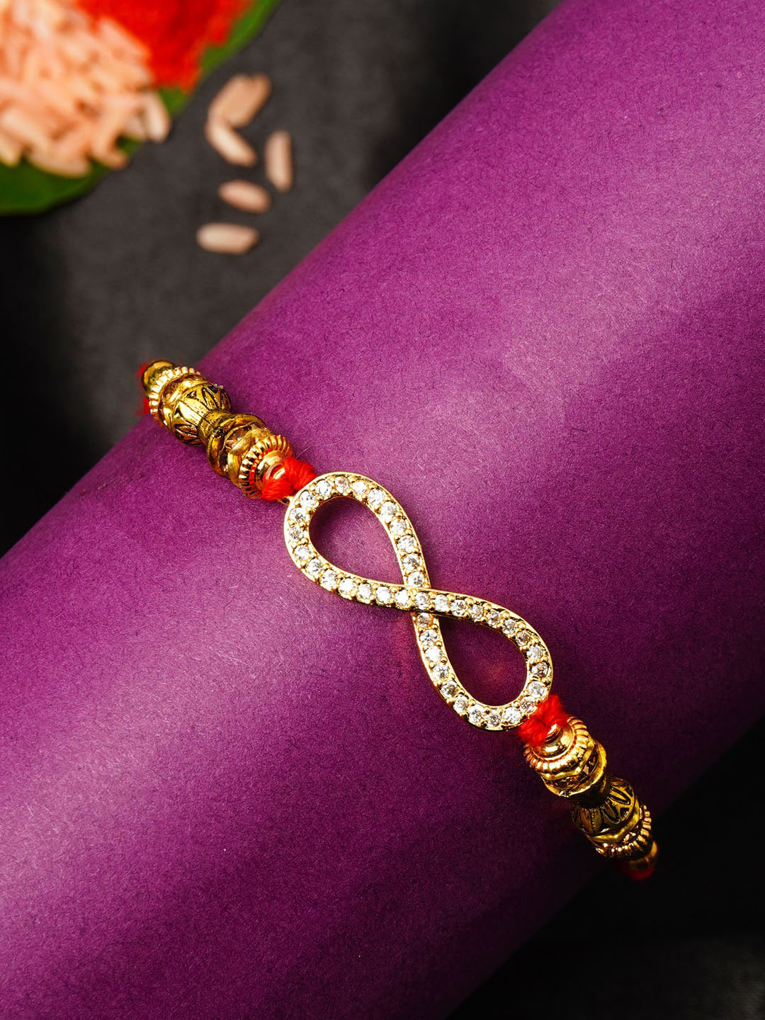 

Urmika Men Gold & Red Stone Studded Thread Rakhi With Roli Chawal