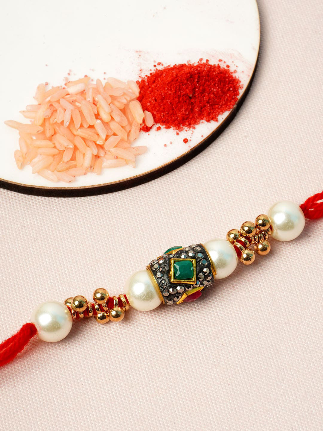 

Urmika Men Gold-Toned & White Pearl-Studded Rakhi Combo