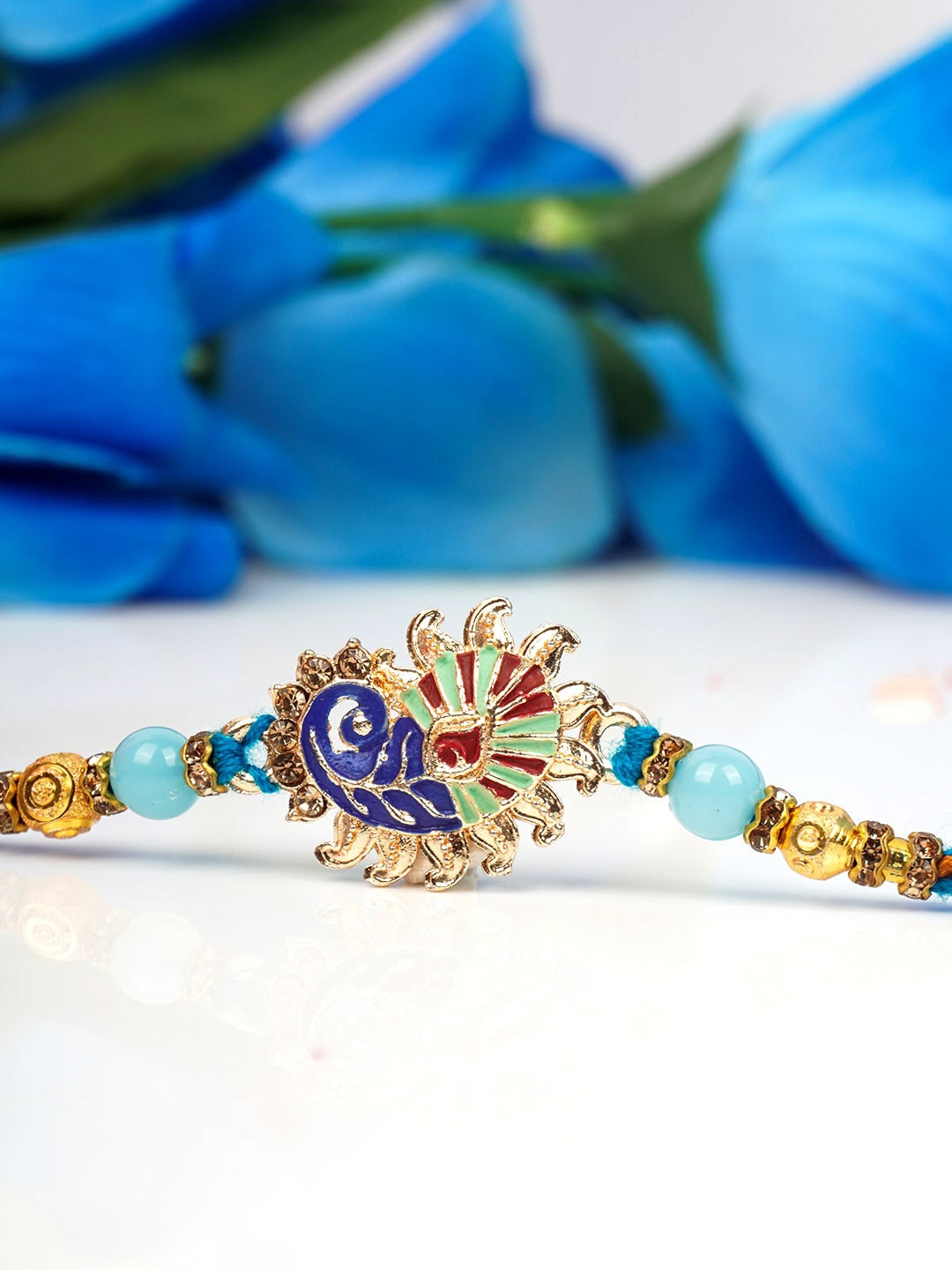 

Urmika Men Blue Peacock Rakhi & Roli Chawal