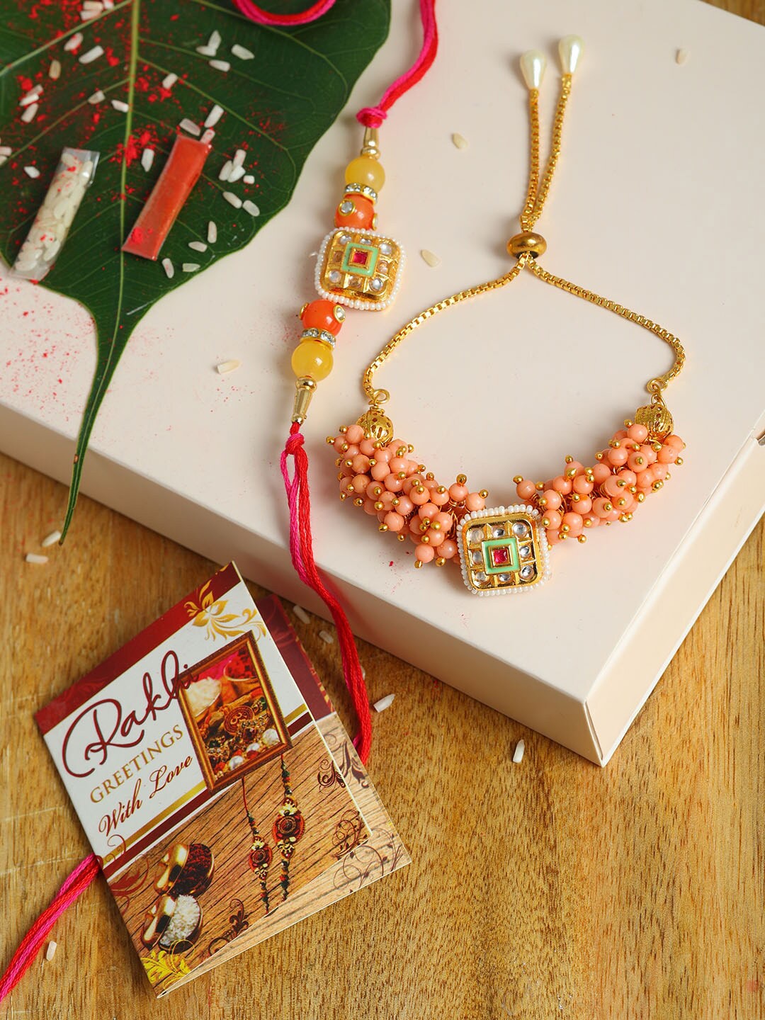 

PASSION PETALS Set Of 2 Bracelet Style Orange Stone Studded Rakhi