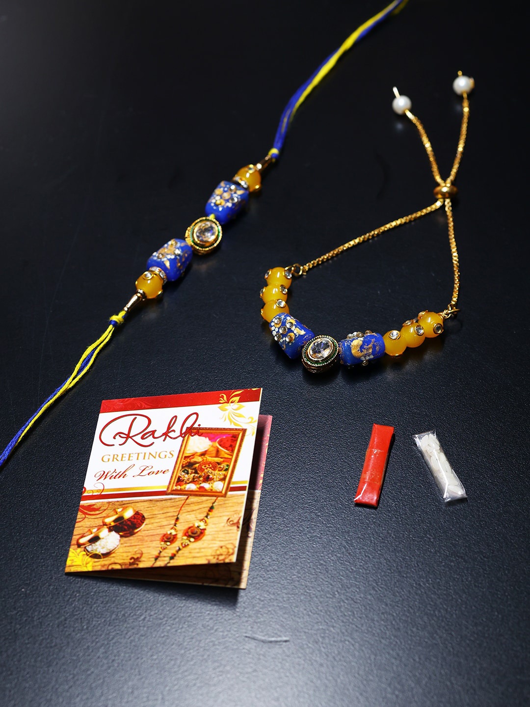 

PASSION PETALS Set Of 2 Bracelet Style Blue Stone Studded Rakhi