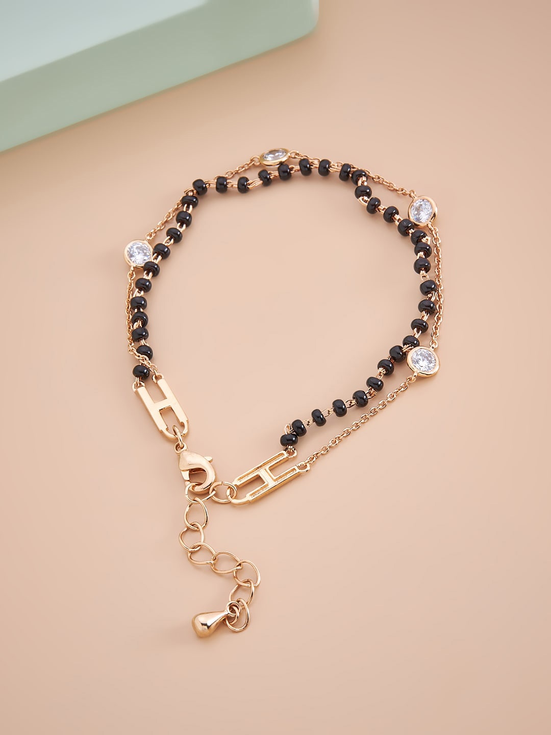 

Kushal's Fashion Jewellery Women Gold-Toned & Black Beaded CZ Studded Wraparound Bracelet