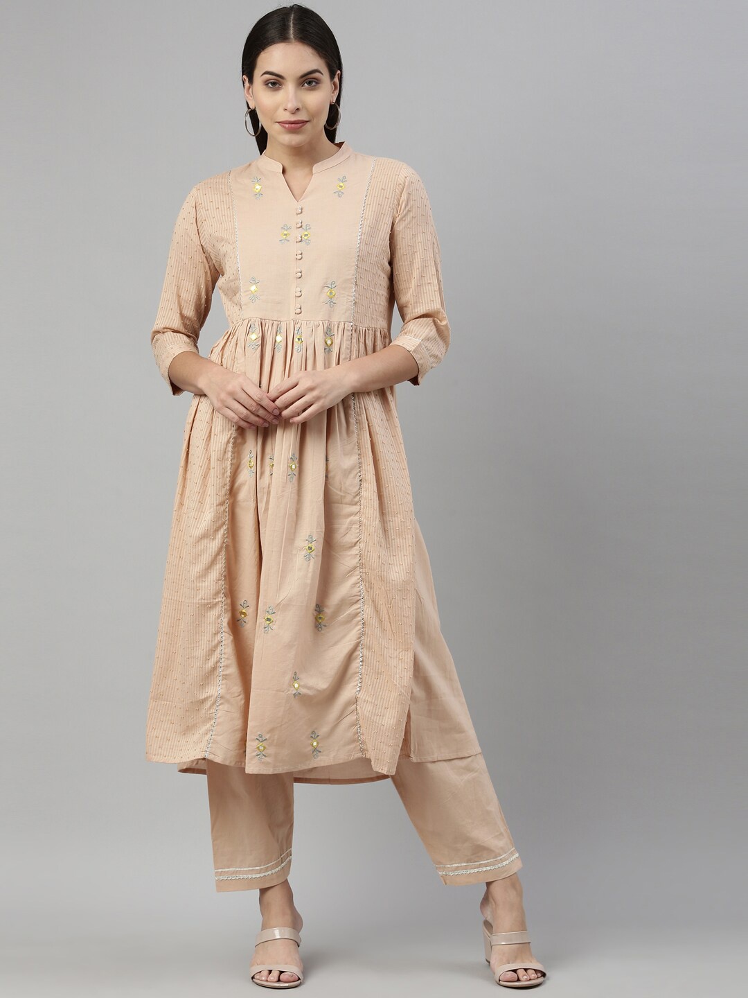 

Neerus Women Beige Floral Embroidered Pleated Aari Work Pure Cotton Kurti with Trousers