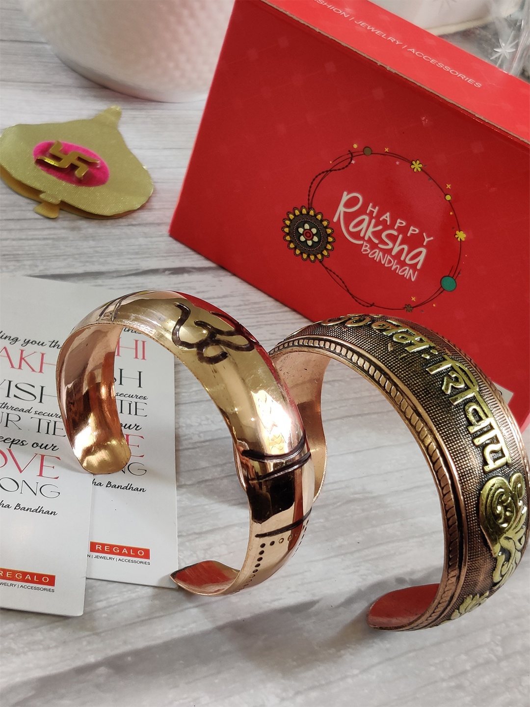 

EL REGALO Bhaiya Bhabhi Om kada Bracelet 2 Pack Rakhi Combo with Greeting Card Roli Chawal, Gold