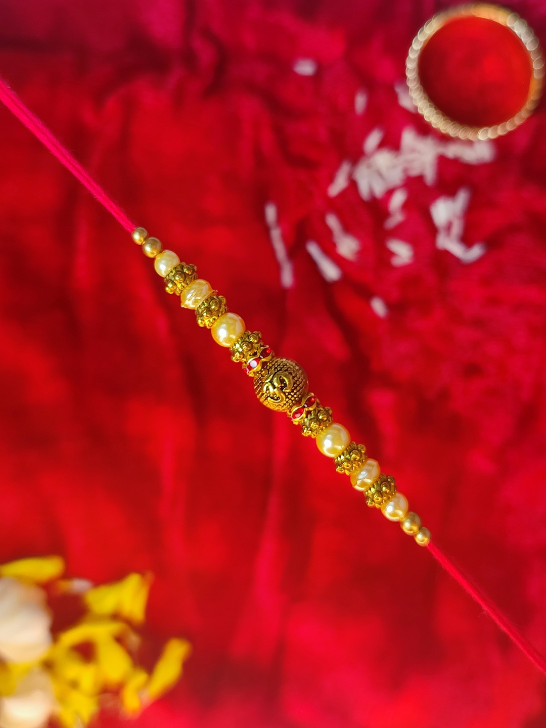 

CRAYTON Men Gold-Toned & Red Om With Pearl Beaded Rakhi