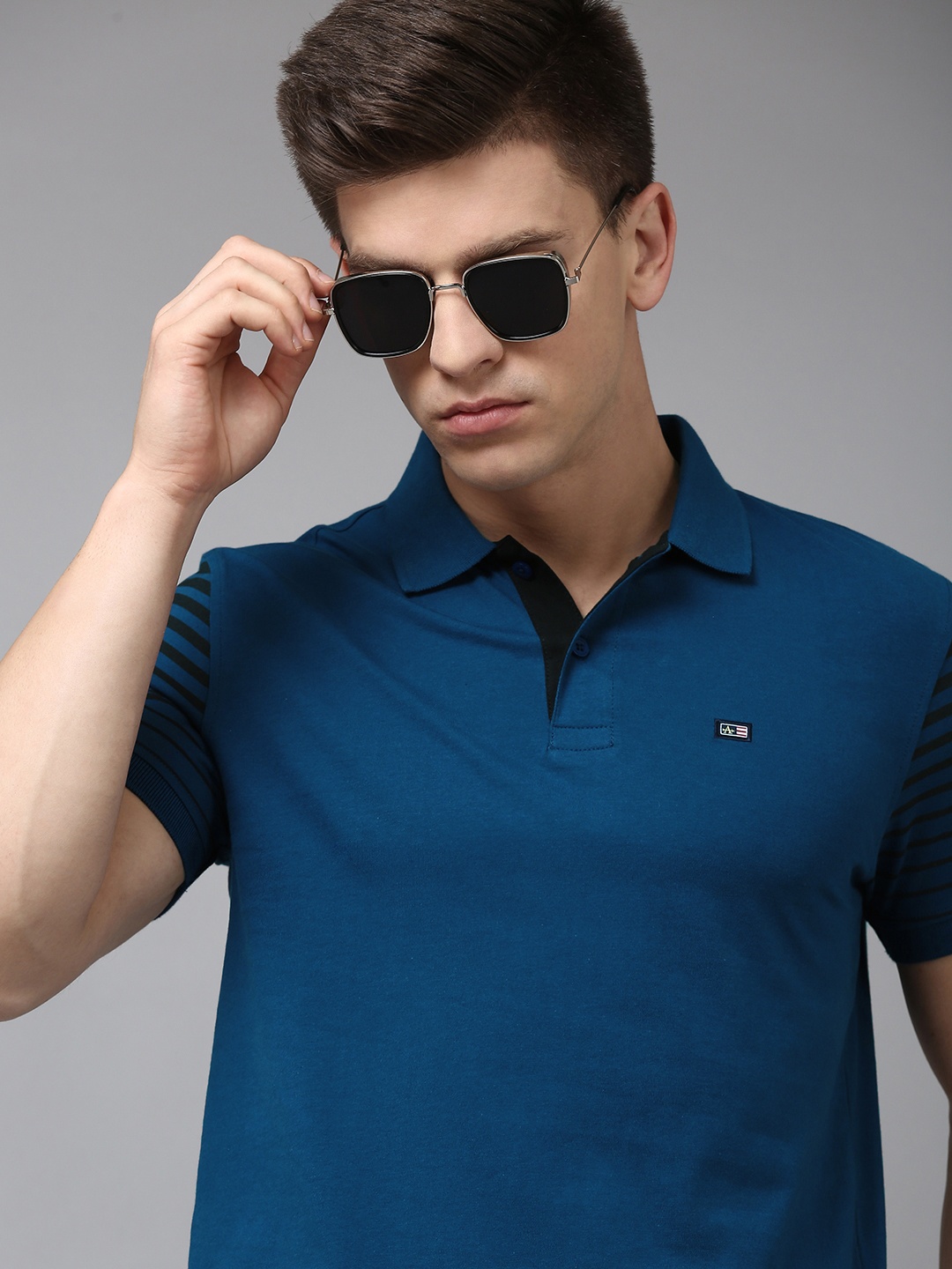 

Arrow Men Solid Polo Collar Pure Cotton T-shirt With Striped Sleeves, Blue