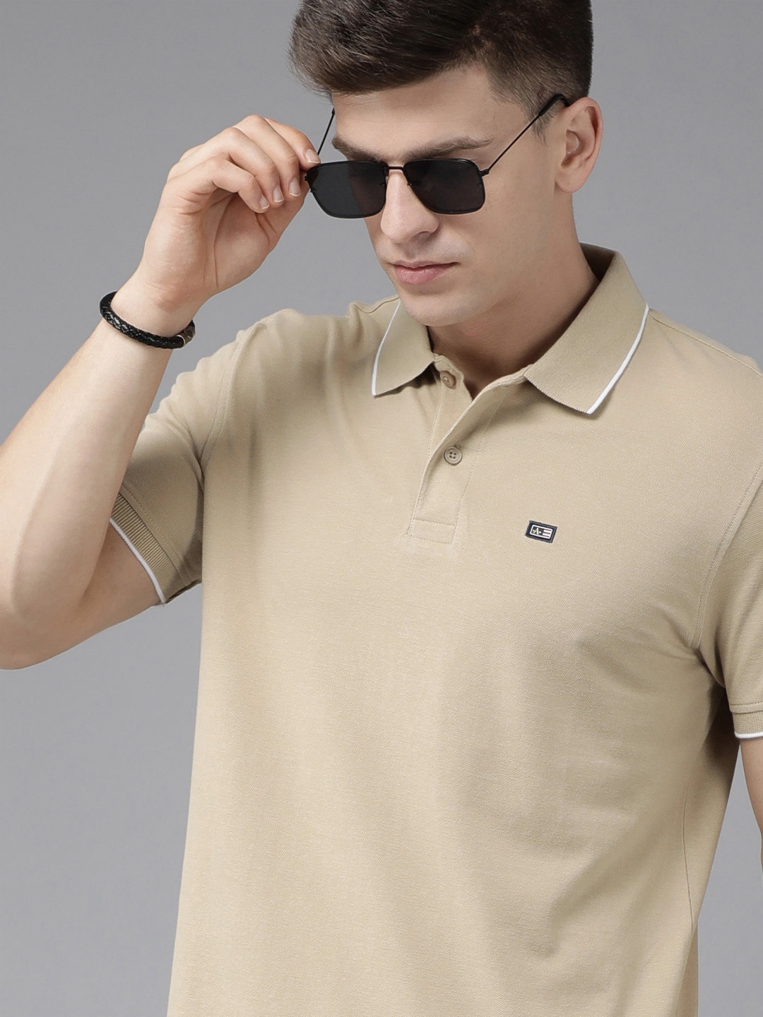 

Arrow Men Beige Solid Polo Collar Embroidered Knitted Pure Compact Cotton Slim Fit T-shirt