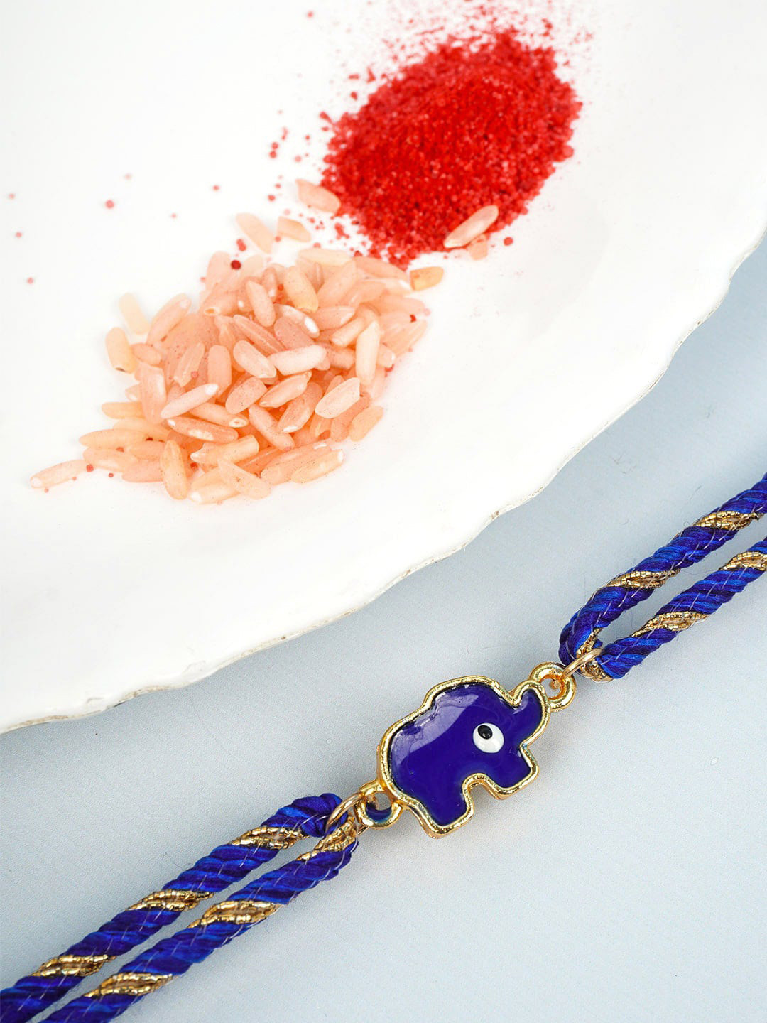 

Ferosh Men Blue & Gold-Toned Elephant Evil Eye-Charm Rakhi With Roli Chawal