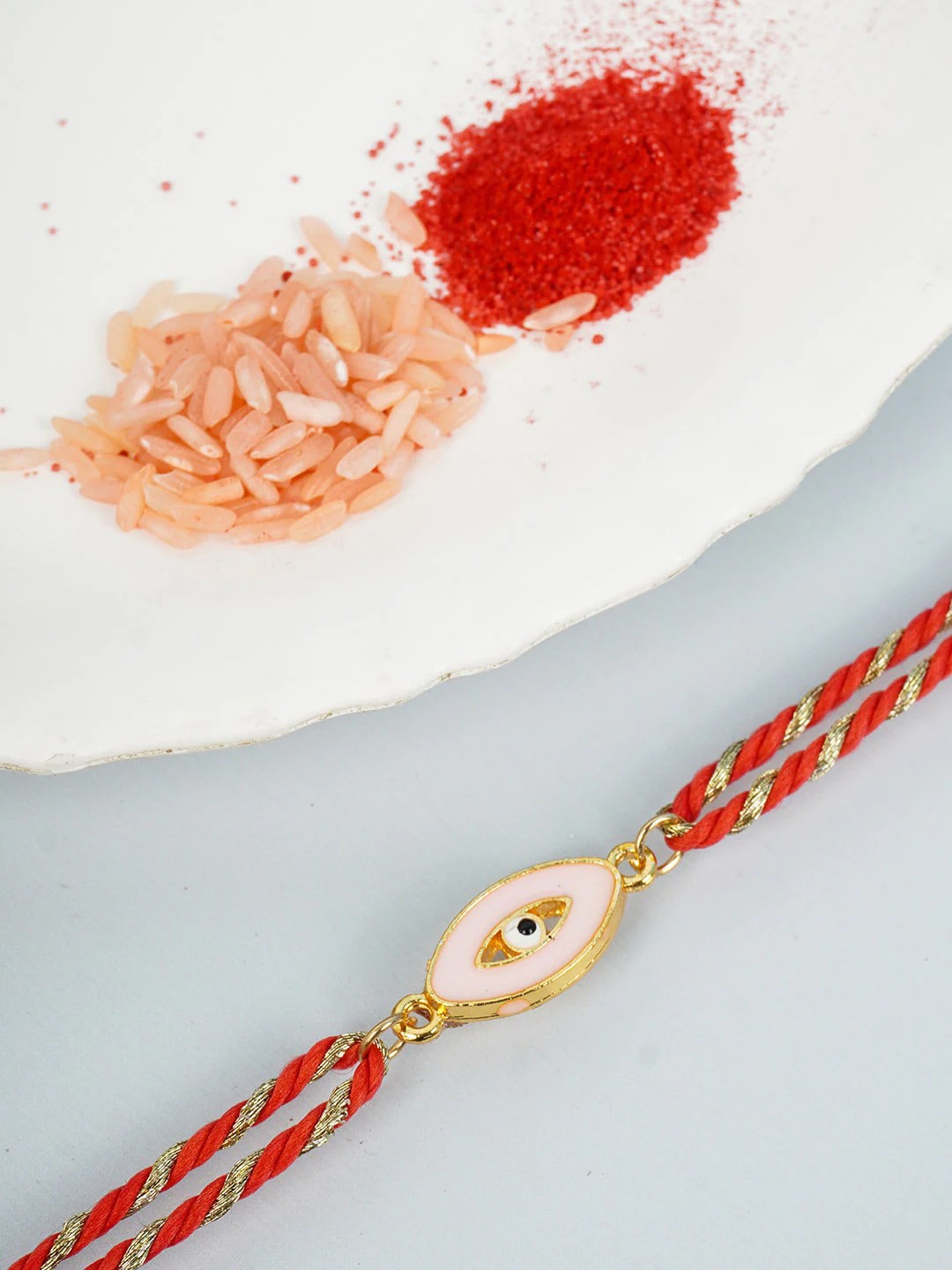 

Ferosh Men Men Gold Toned Red & White Beaded Evil Eye Rakhi