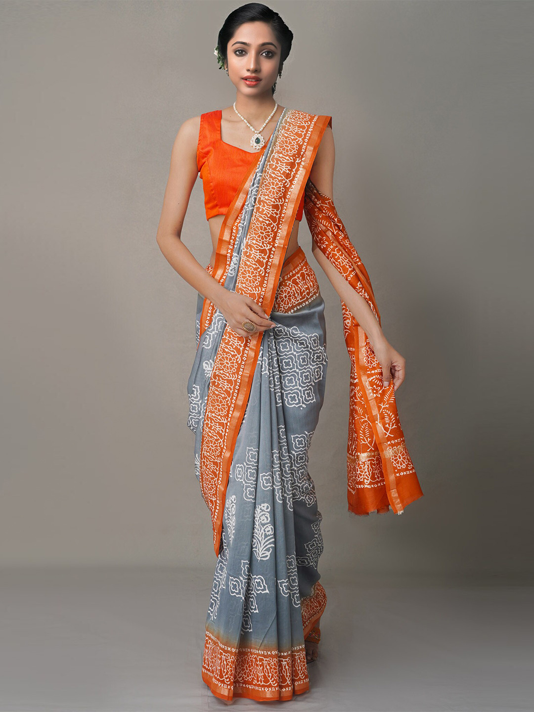 

Unnati Silks Grey & Orange Ethnic Motifs Baluchari Saree