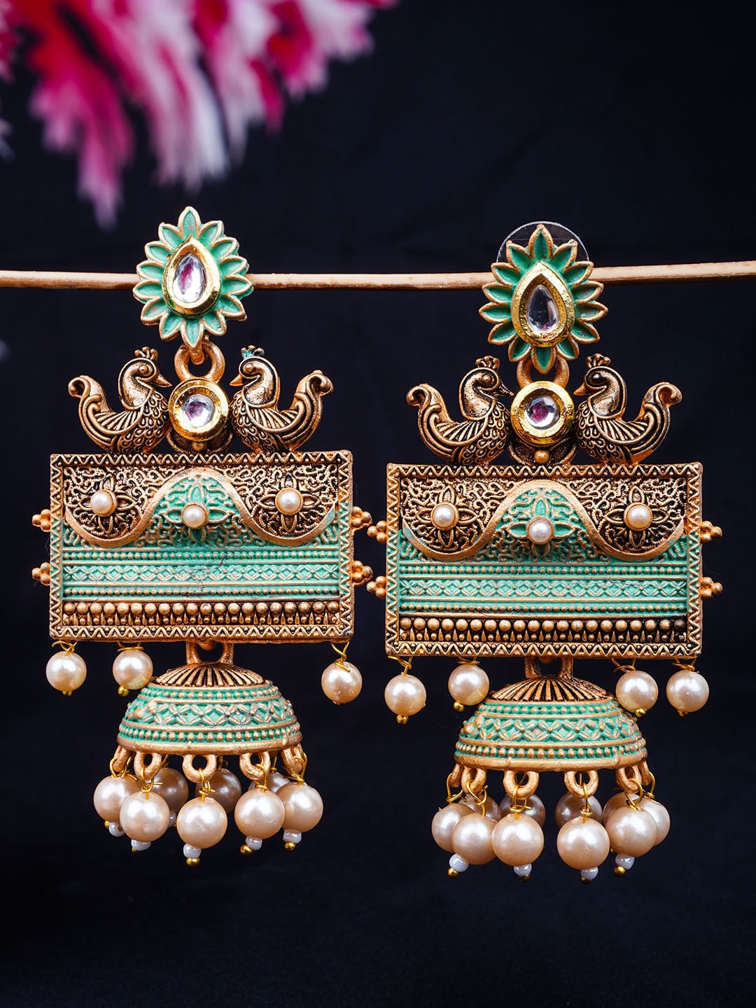 

Urmika Green Gold-Toned Antique Jhumkas Earrings