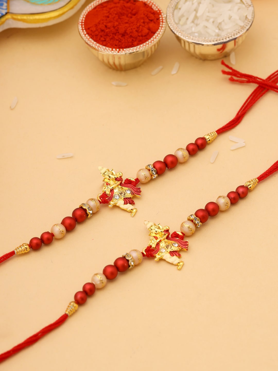 

Natures Buggy Men Set Of 2 Red & Gold-Coloured Ganesha Idol Beaded Rakhi
