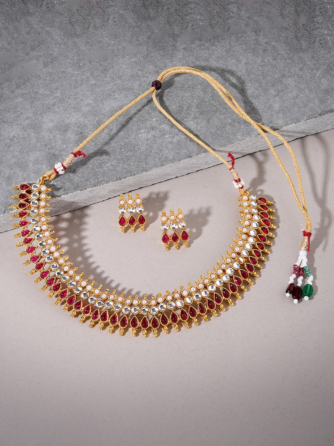 

Fida Women south Indian Antique Gold-Plated Red Kundan-Studded & Beaded Jewellery Set