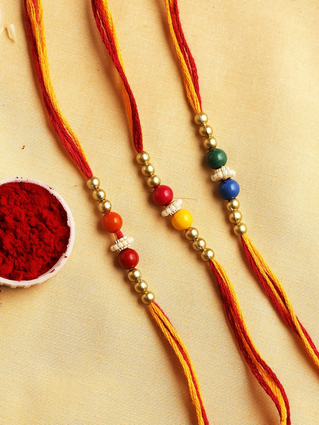 

Aapno Rajasthan Set of 3 Multicolored Beaded Thread Rakhi, Multi