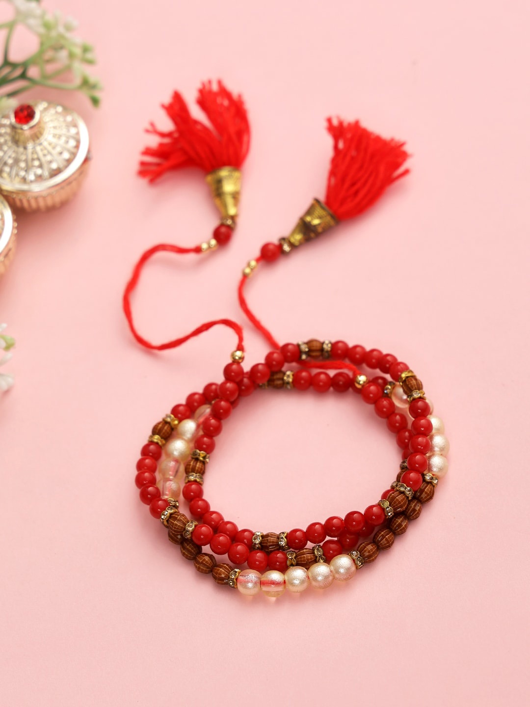 

Aapno Rajasthan Brown & Red Pearl & Beads Bracelete Rakhi