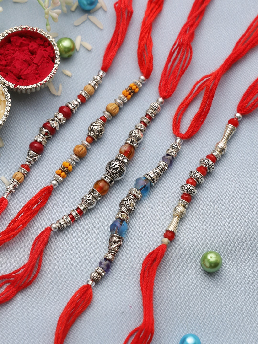 

Aapno Rajasthan Set of 5 Silver & Red Beads Rakhis