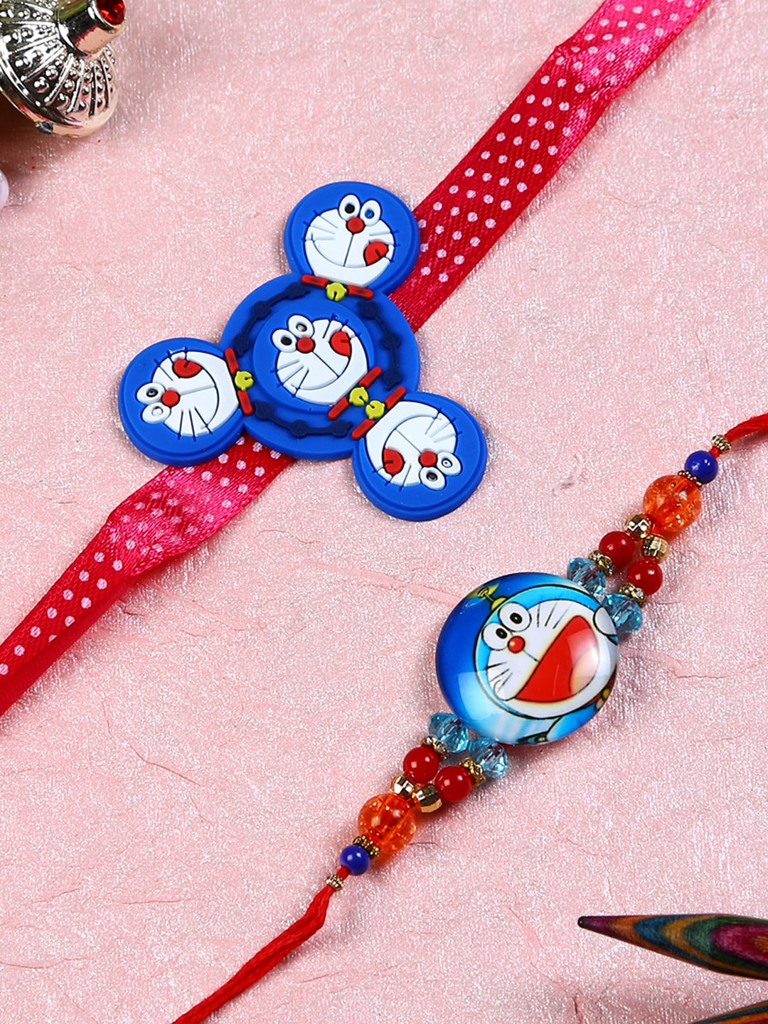 

Aapno Rajasthan Blue & Red Set of 2 Doraemon Rakhi with Roli Chawal & Card