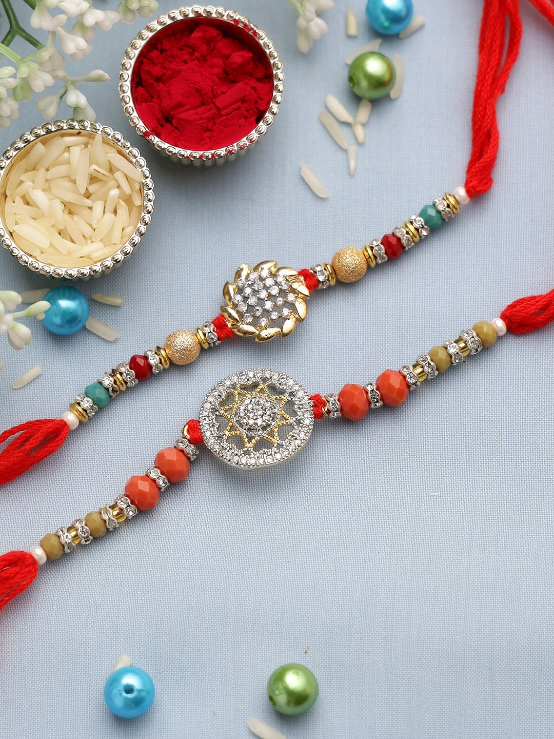 

Aapno Rajasthan 2 Pieces Multicoloured Studded Thread Rakhi Set, Multi