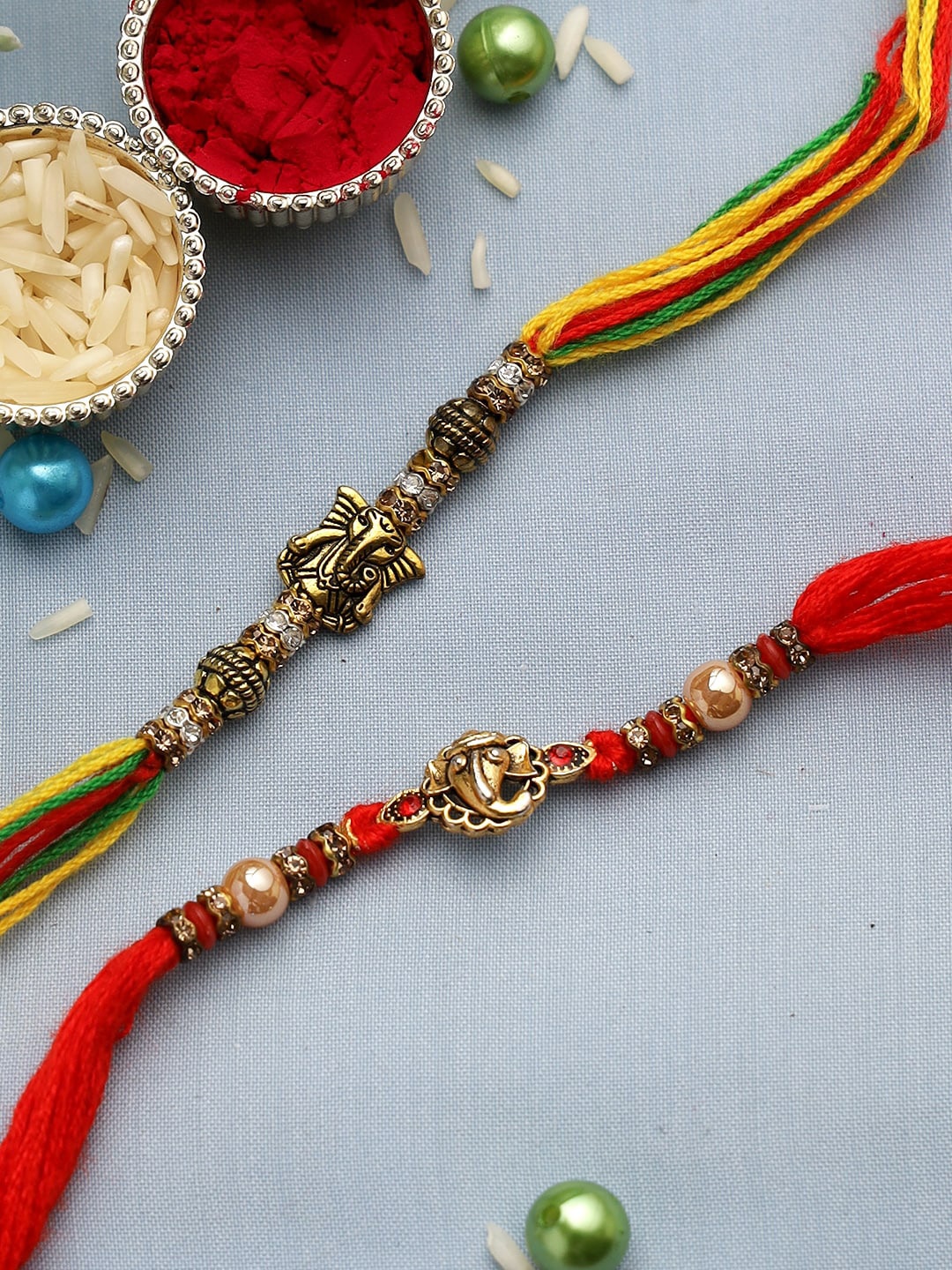 

Aapno Rajasthan Set of 2 Red & Yellow Small Antique Ganesha Rakhis