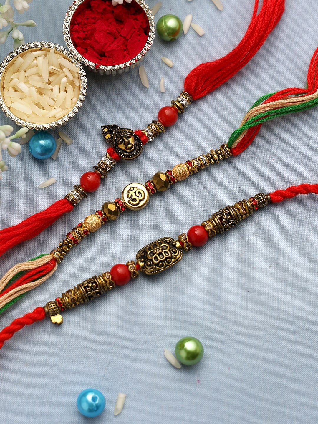 

Aapno Rajasthan Set of 3 Gold & Red Divine Rustic Finish Rakhi