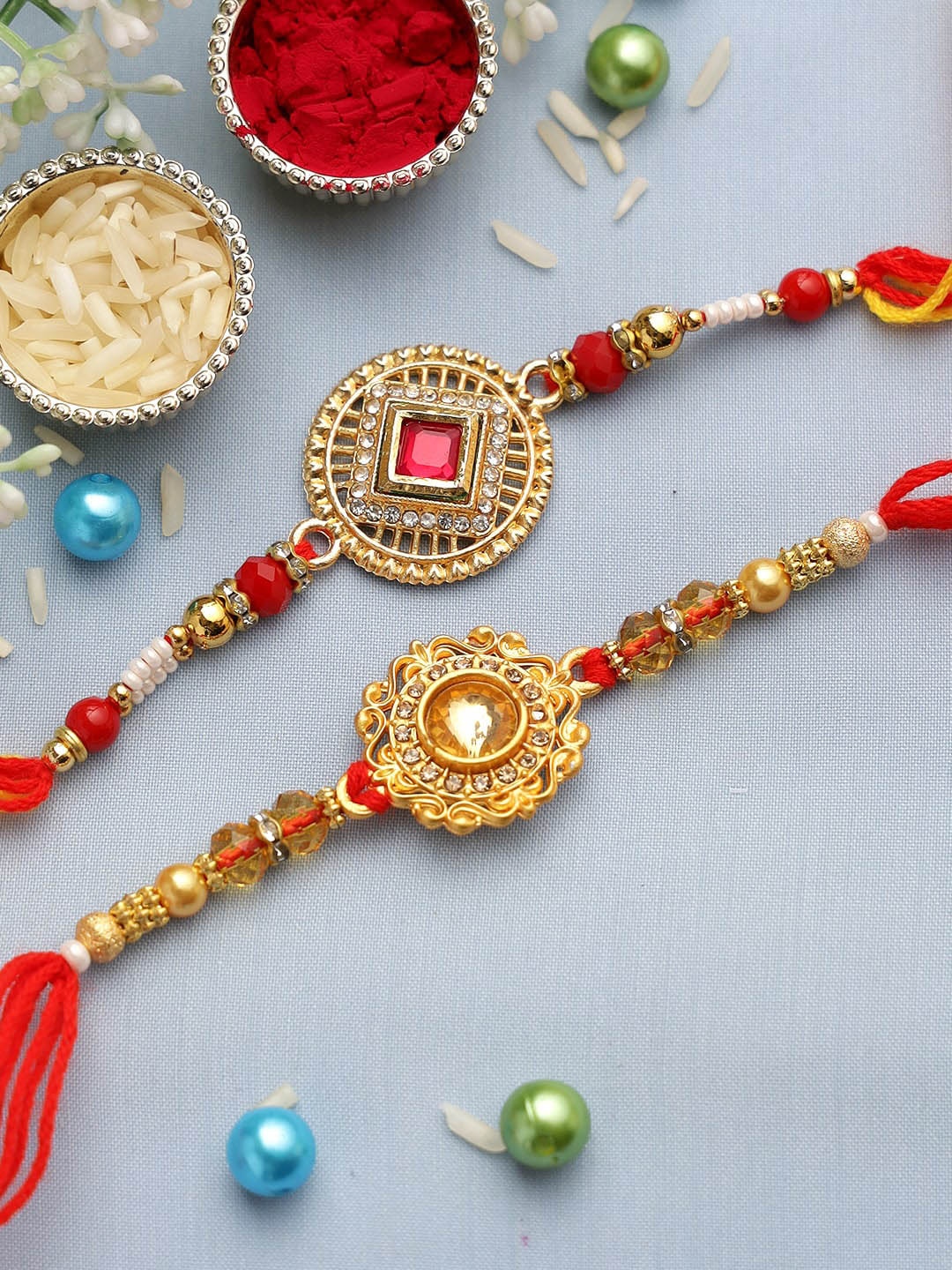 

Aapno Rajasthan Set of 2 Gold-Toned & Red Beaded Rakhi