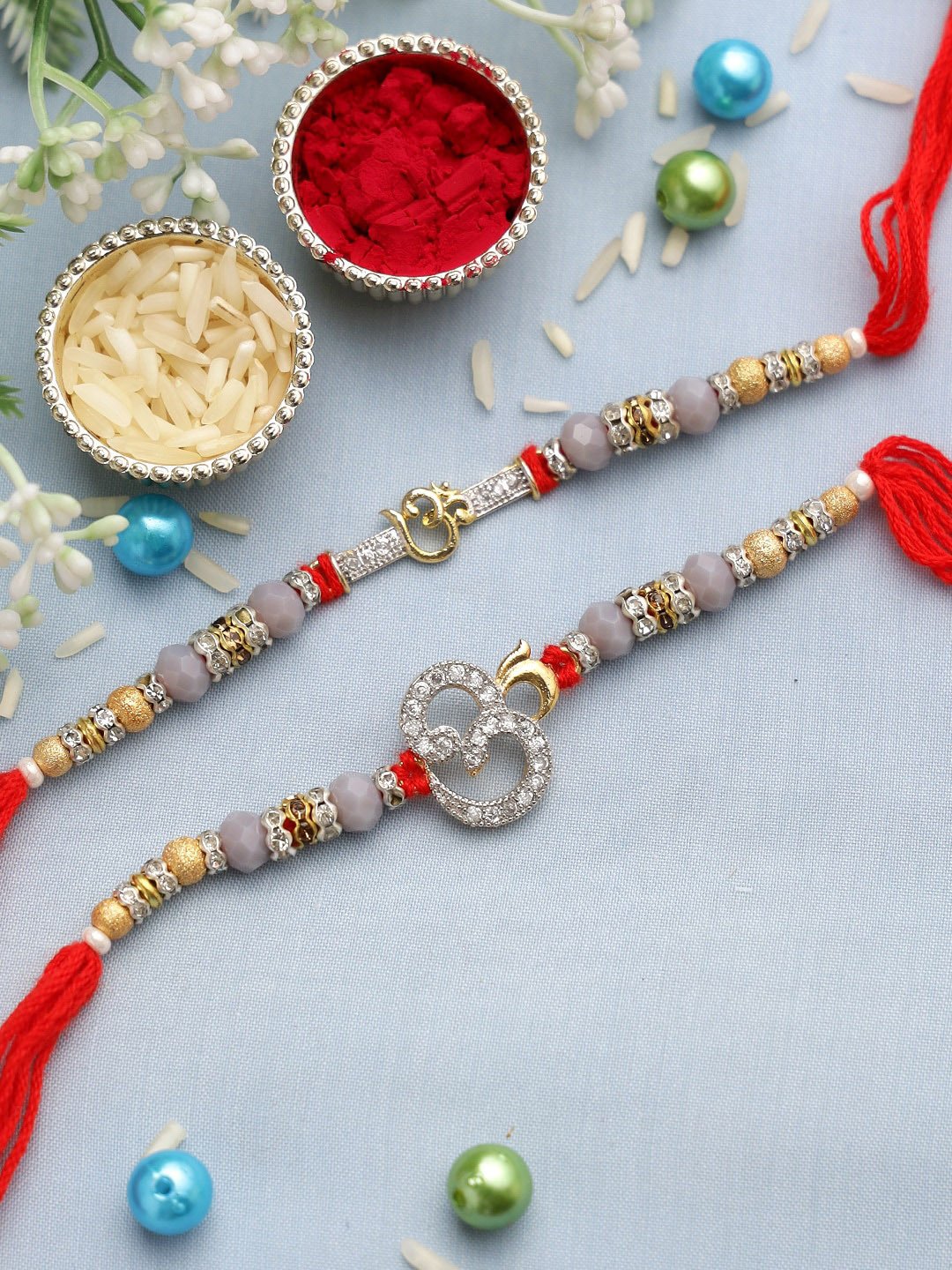 

Aapno Rajasthan Set of 2 Grey & Red Rakhis with Roli Chawal & Card