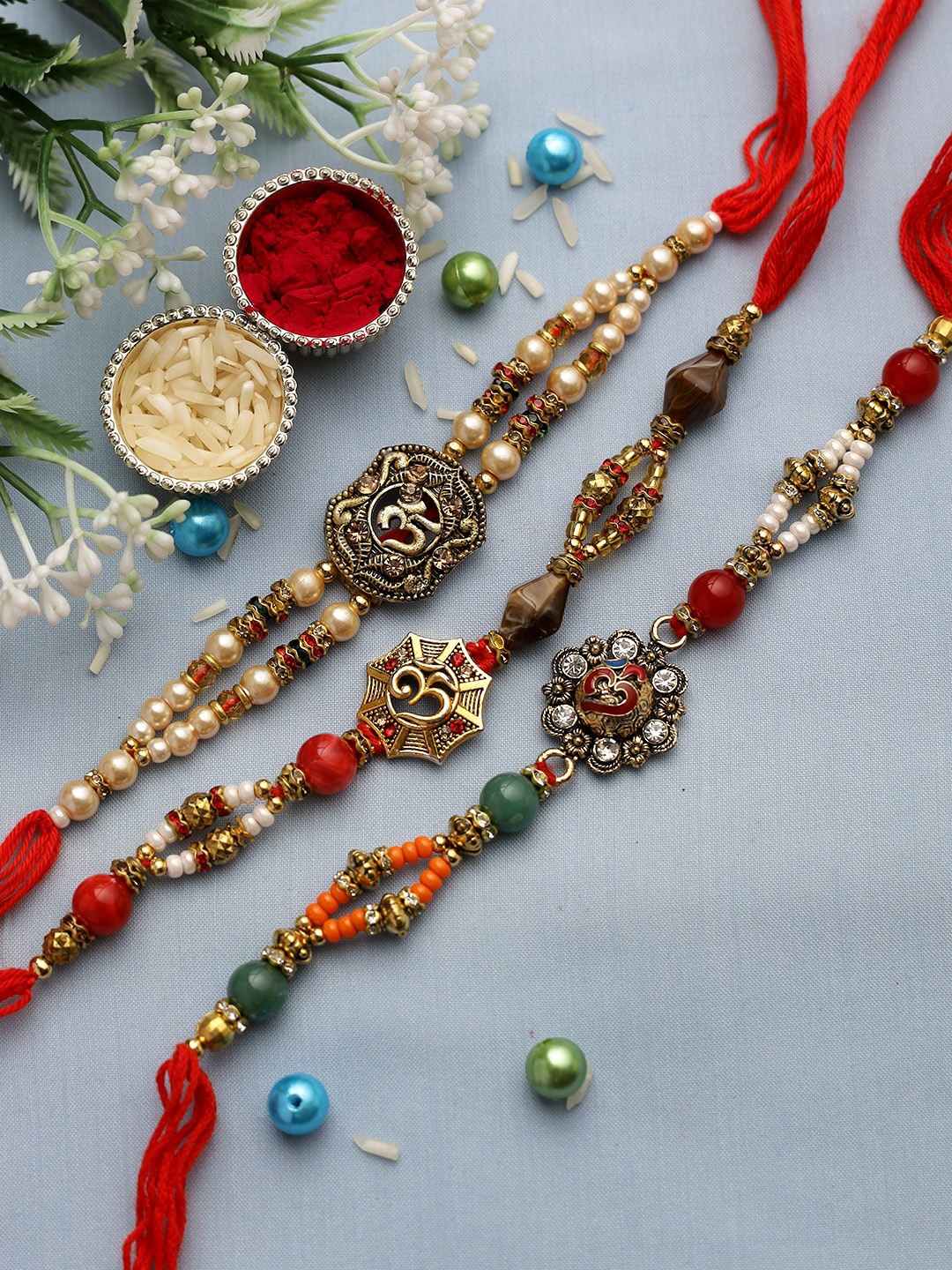 

Aapno Rajasthan Set of 3 OM Rakhi Set, Red