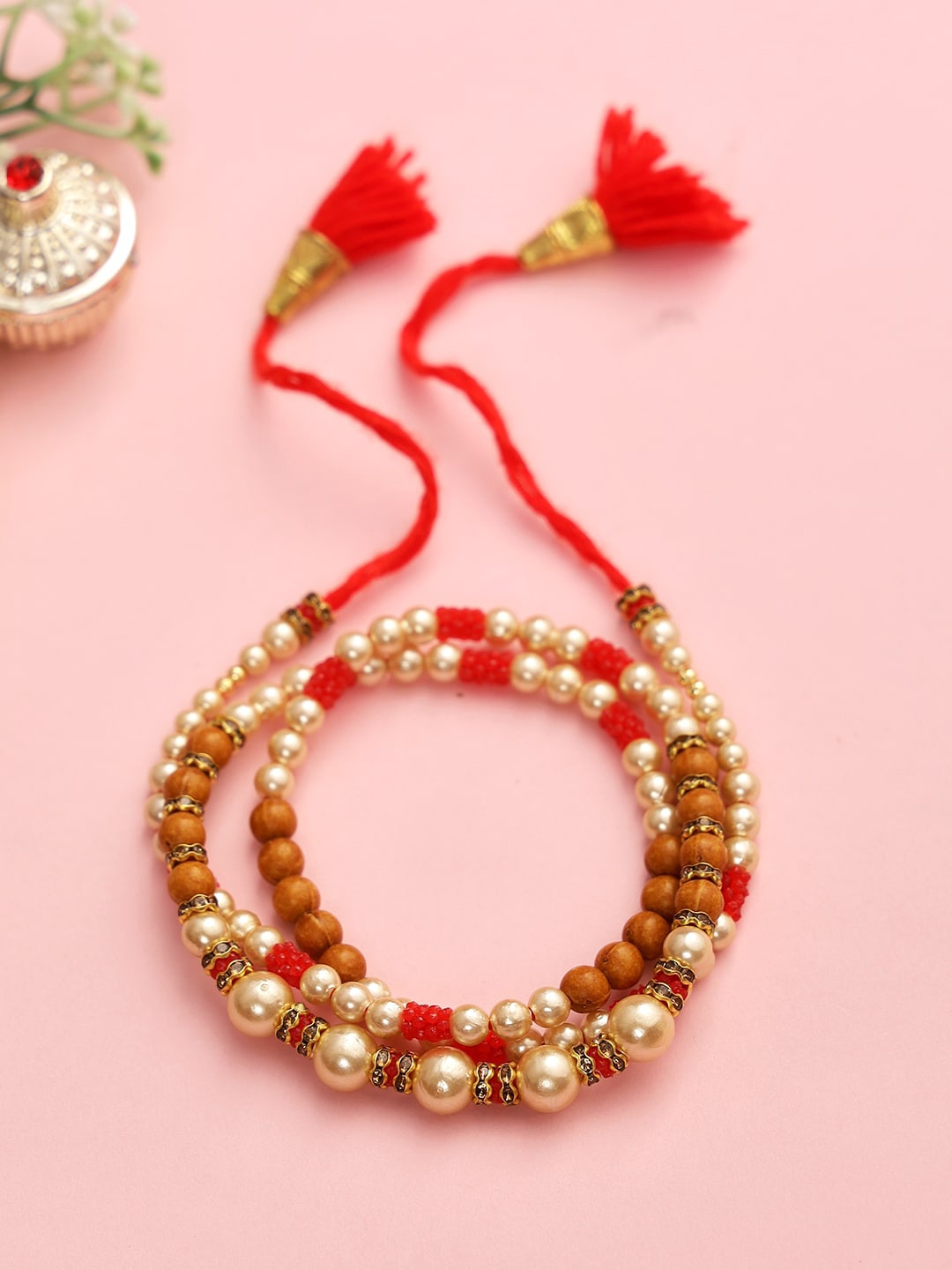 

Aapno Rajasthan Brown & Red Pearl and Beads Bracelete Rakhi