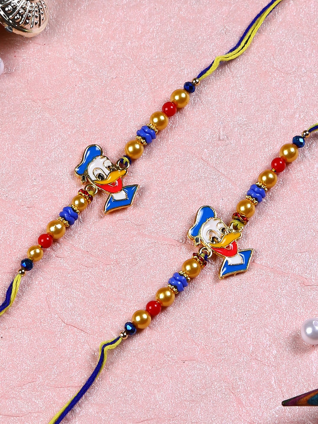 

Aapno Rajasthan Set of 2 Blue & Golden Donald Duck Cartoon Rakhis