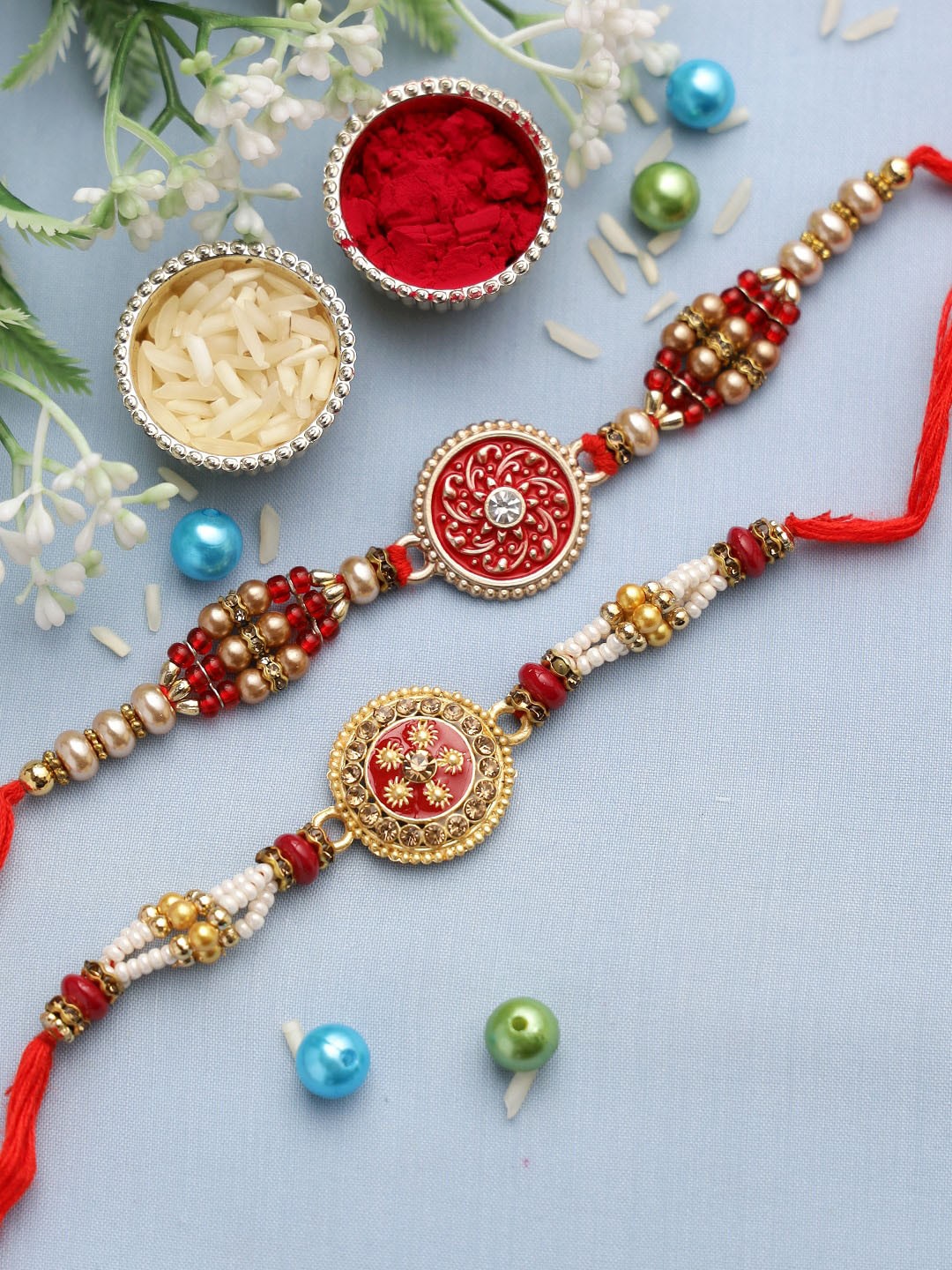

Aapno Rajasthan Set Of 2 Red & Gold-Toned Beaded Rakhis