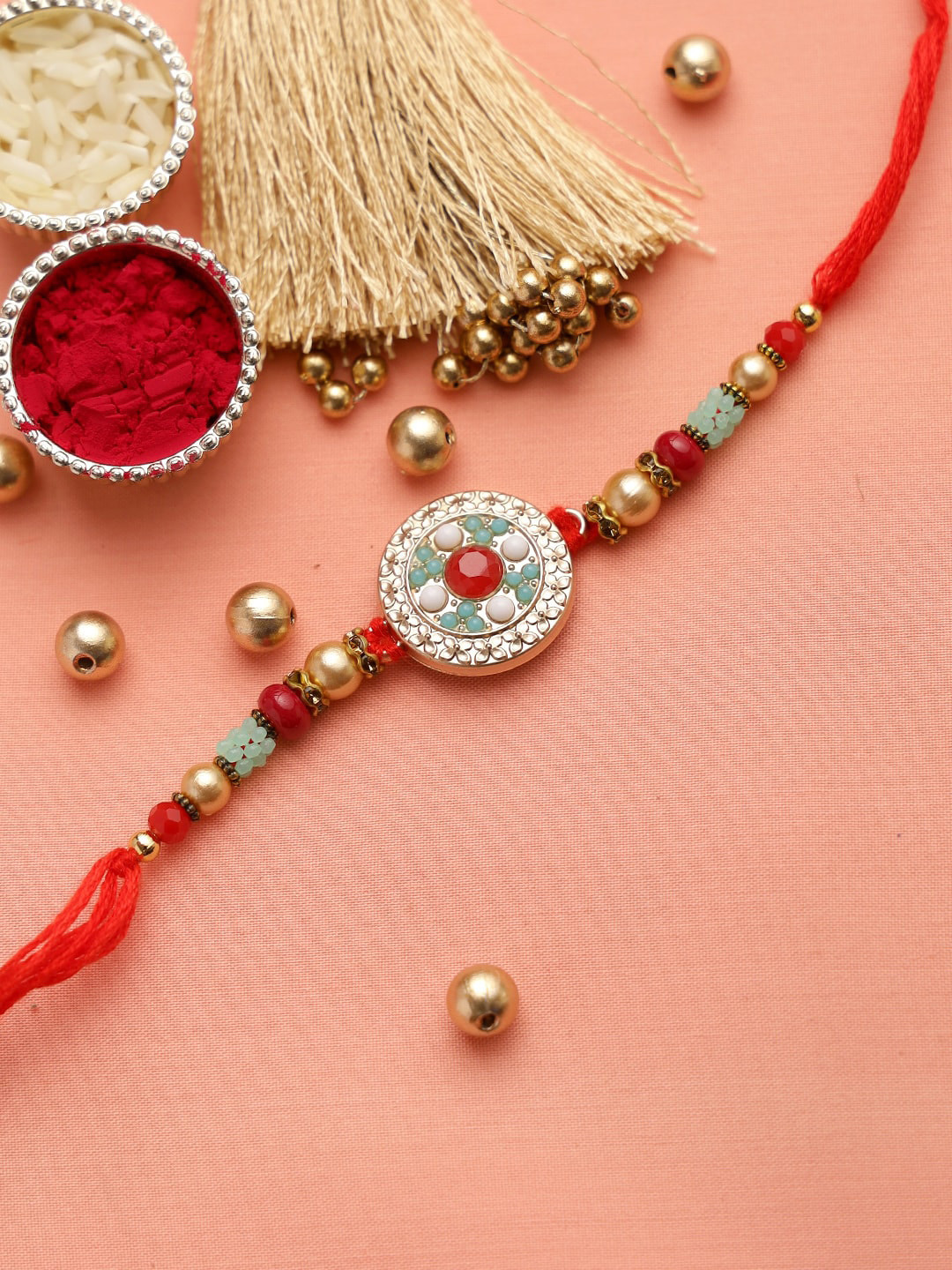 

Aapno Rajasthan Turquoise Blue and Golden Beads Traditional Rakhi
