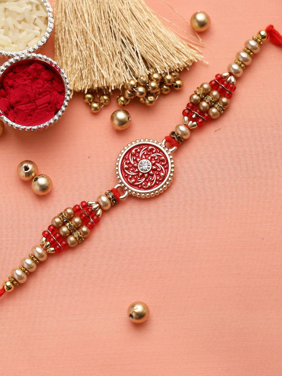 

Aapno Rajasthan Traditional Meena Work Jewelled Rakhi With Golden Beads & Roli Chawal, Red
