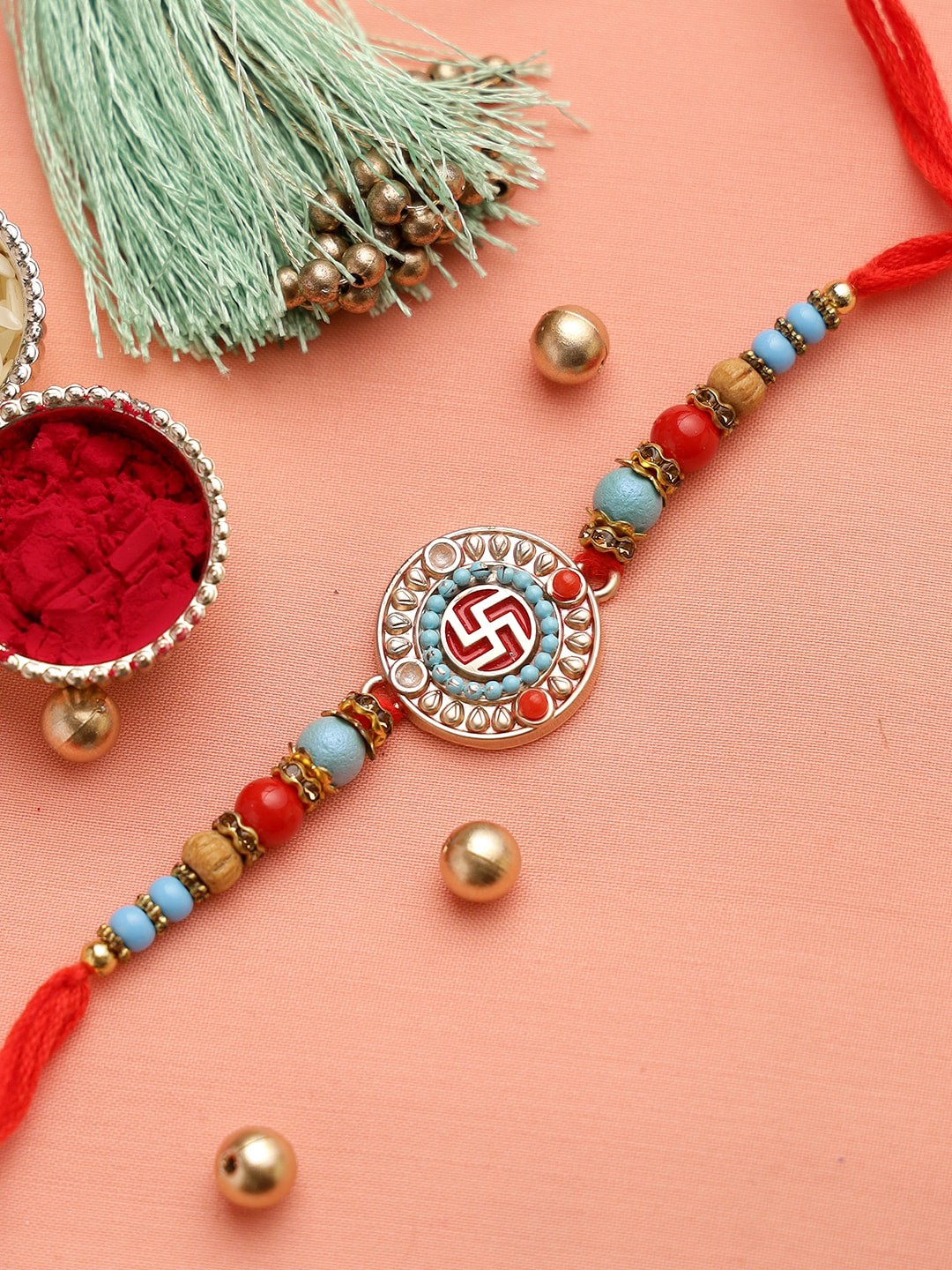 

Aapno Rajasthan Red & Turquoise Blue Beaded Swastik Rakhi with Roli Chawal & Card