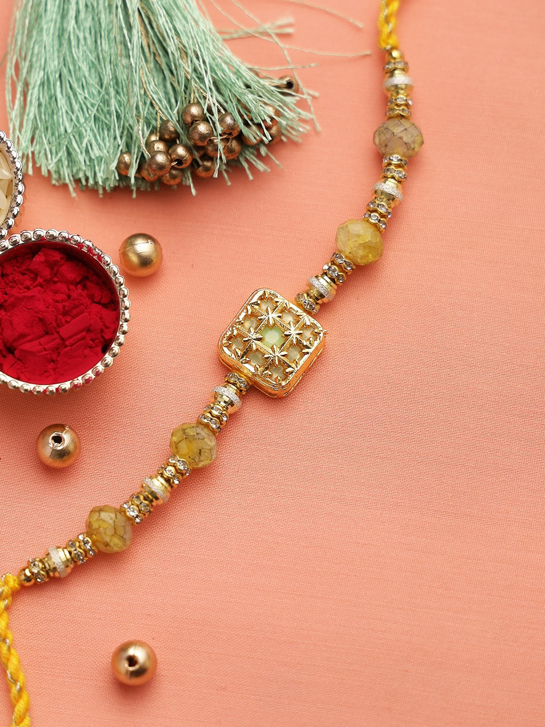 

Aapno Rajasthan Yellow Stone-Studded Rakhi