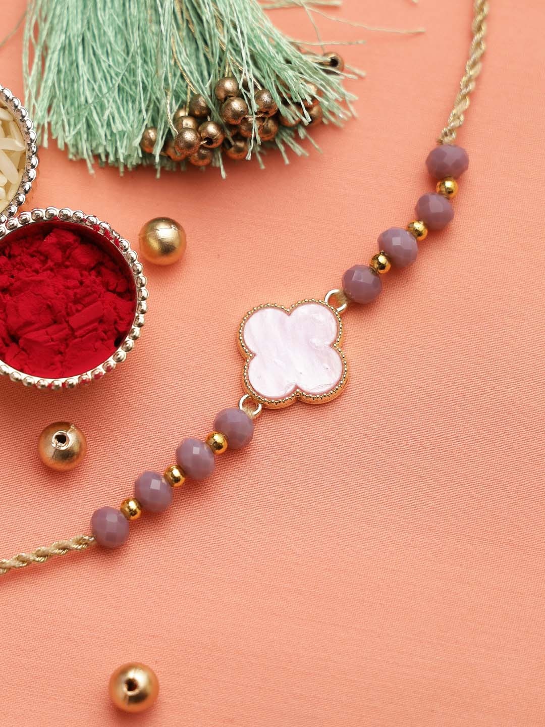 

Aapno Rajasthan Multi-Coloured Beaded Thread Rakhi With Card & With Roli Rice