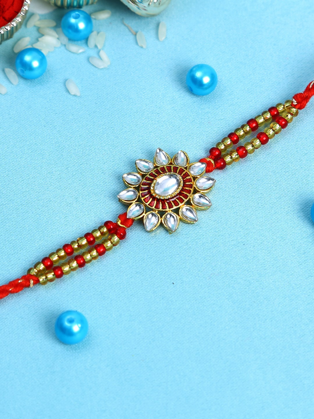 

Aapno Rajasthan Red & Golden Sun Design Kundan Work Glass Beads Rakhi