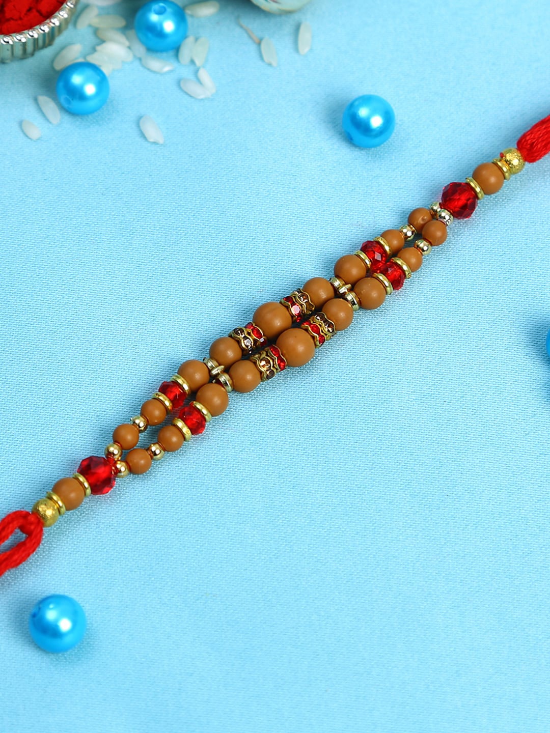 

Aapno Rajasthan Red & Brown Wooden Beaded Rakhi with Golden Rings