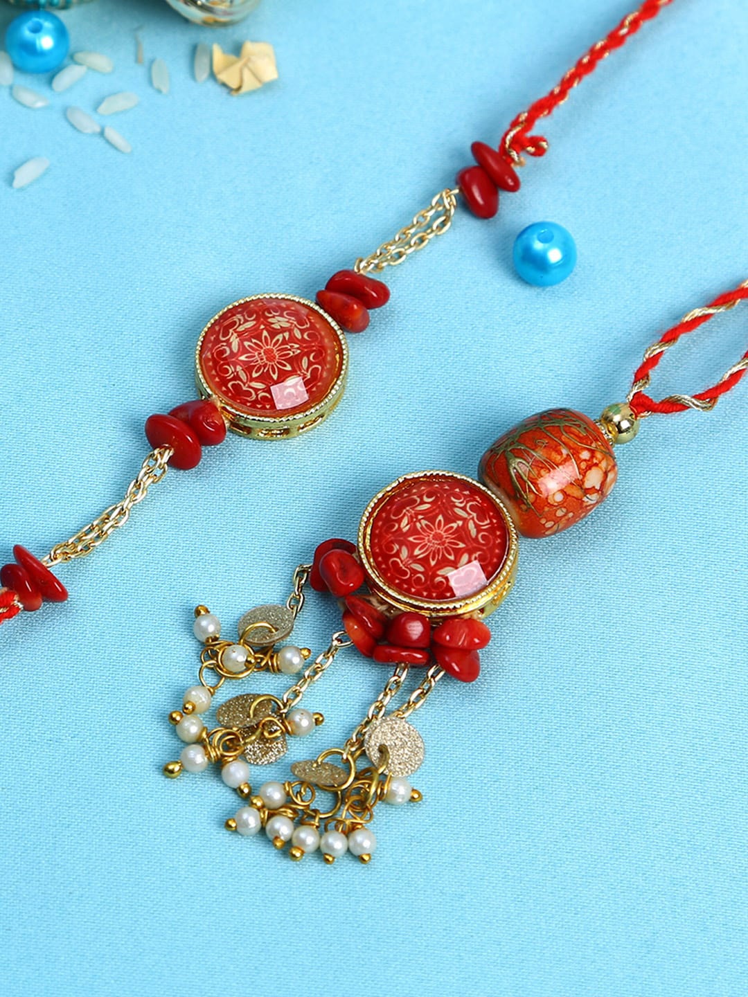 

Aapno Rajasthan Red Stones and Pearl Bhaiya Bhabhi Rakhi Set