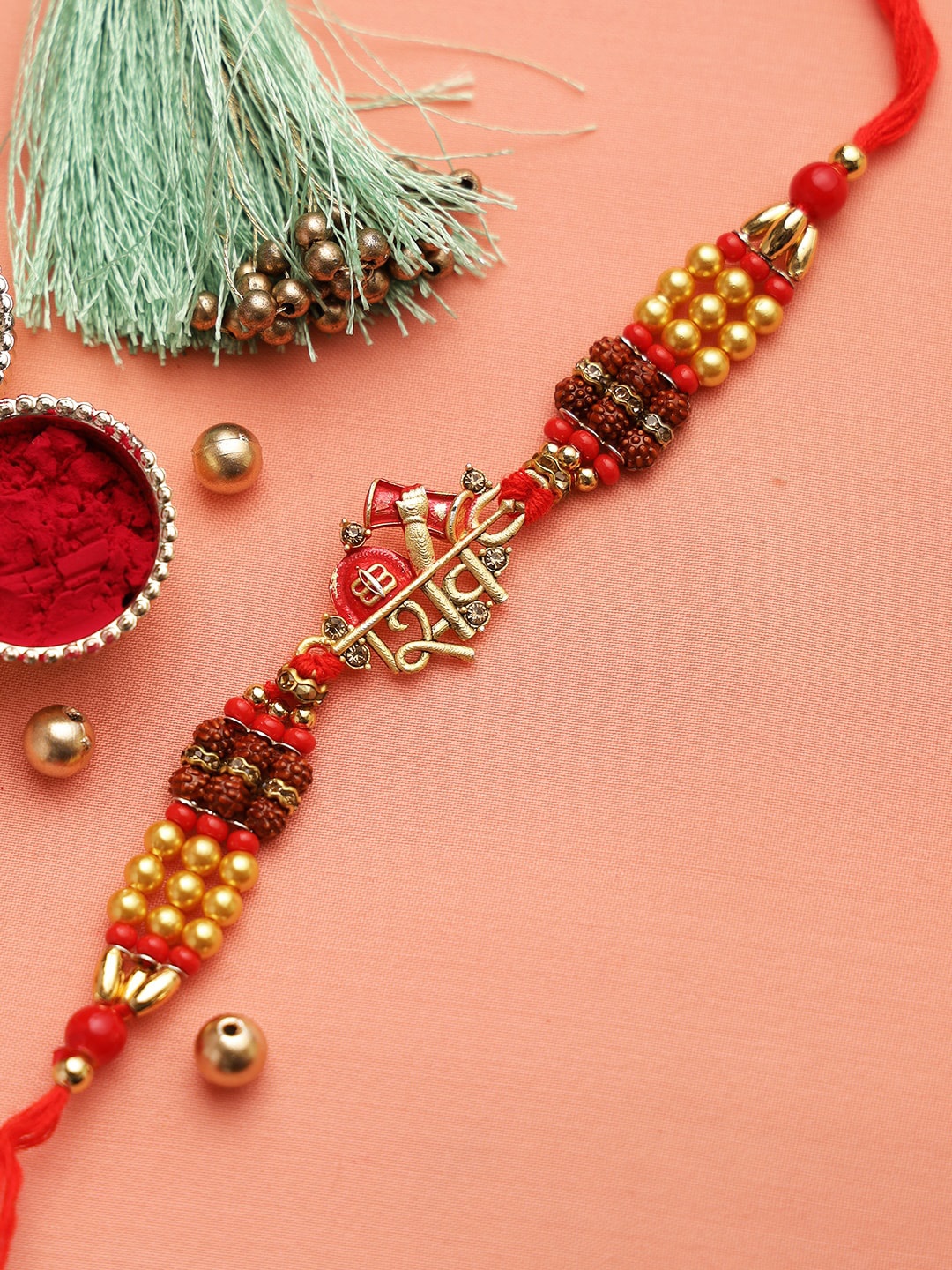 

Aapno Rajasthan Red & Gold-Toned Lord Shiva Stone-Studded Rakhi