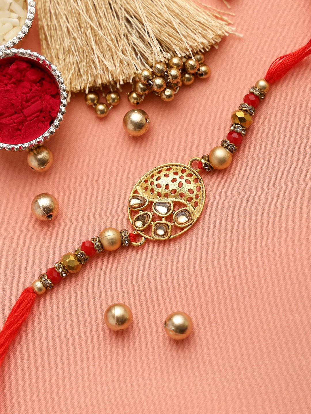 

Aapno Rajasthan Gold-Toned & Red Kundan Stone Rakhi