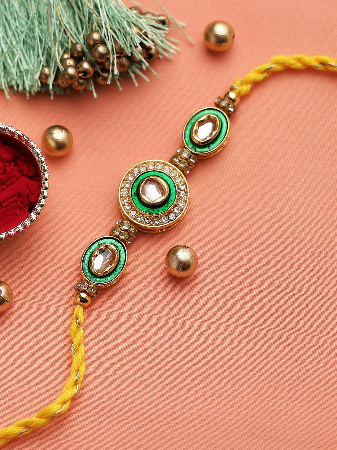 

Aapno Rajasthan Green & Yellow Kundan and Meena Work AD Rakhi