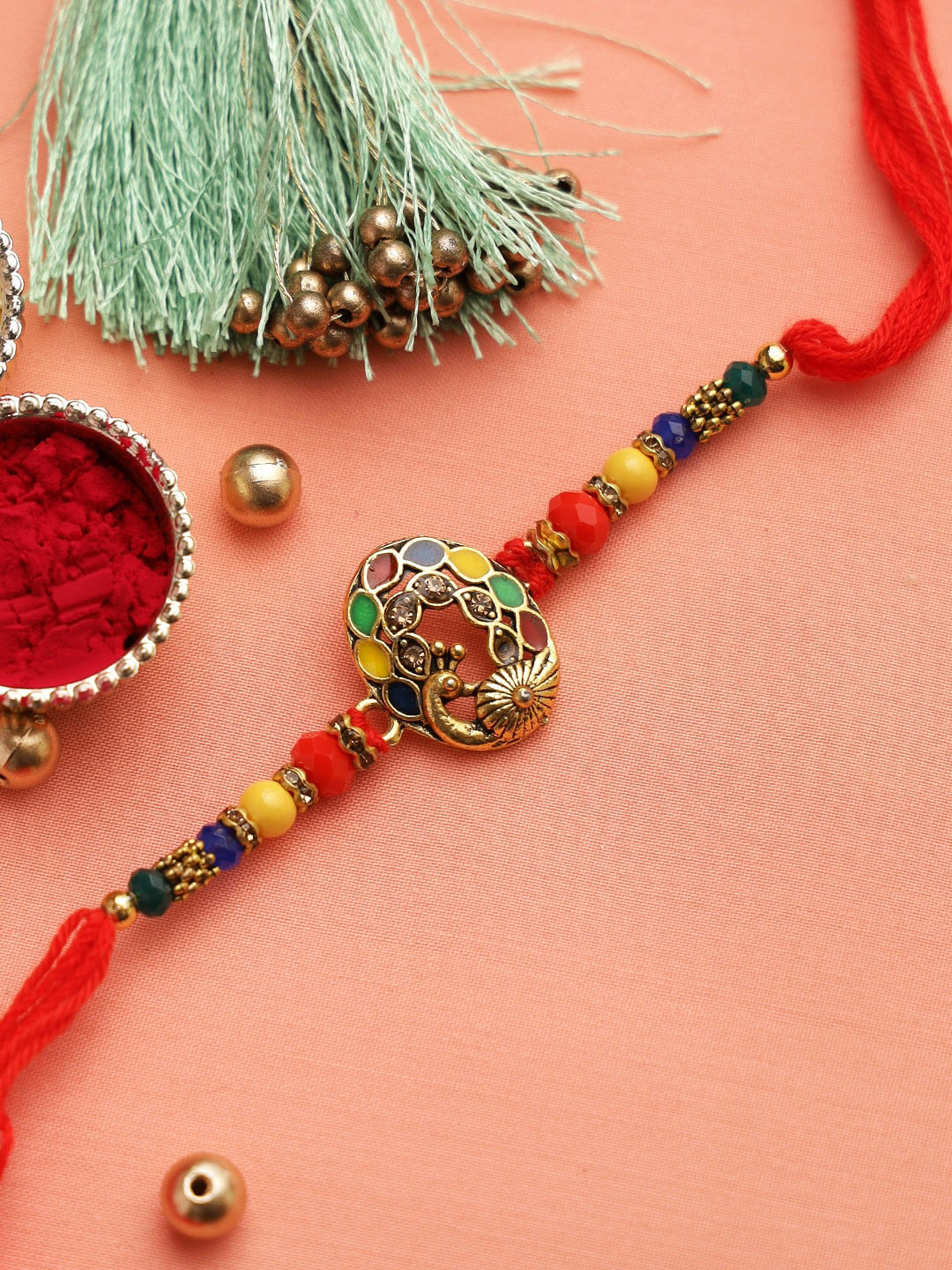 

Aapno Rajasthan Multicoloured Beaded Meenakari Peacock Rakhi, Red