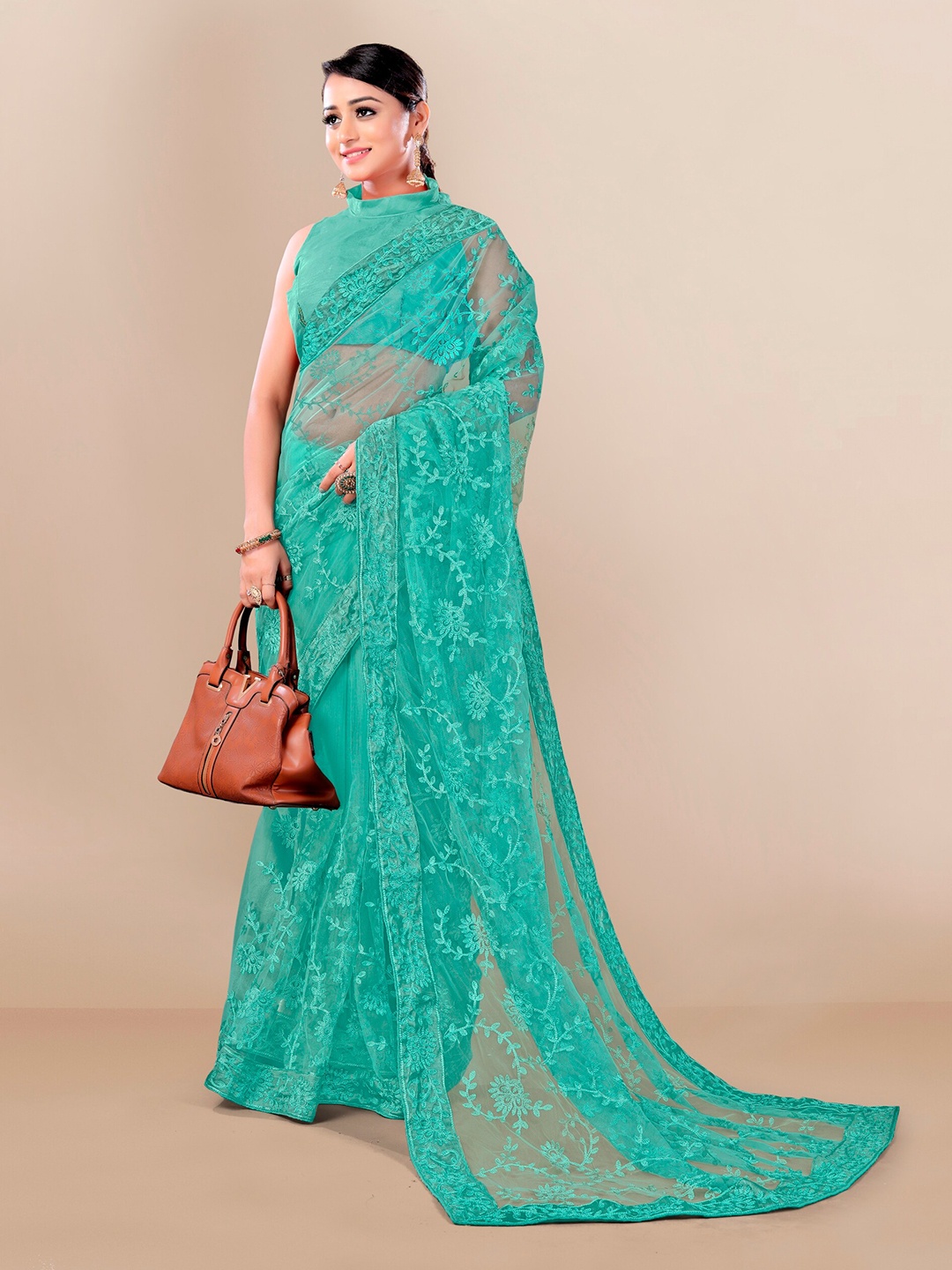 

VAIRAGEE Women Teal Floral Embroidered Net Saree