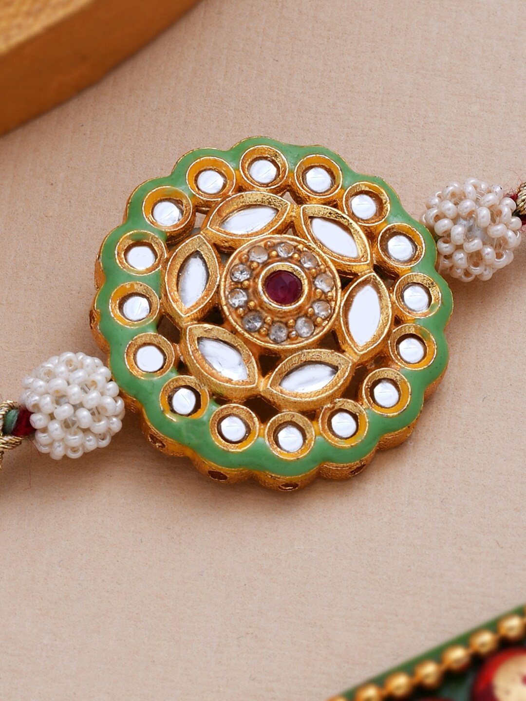

Dare by Voylla Meenakari Enameled Rakhi Studded with Kundan And CZ Sparkling, Maroon