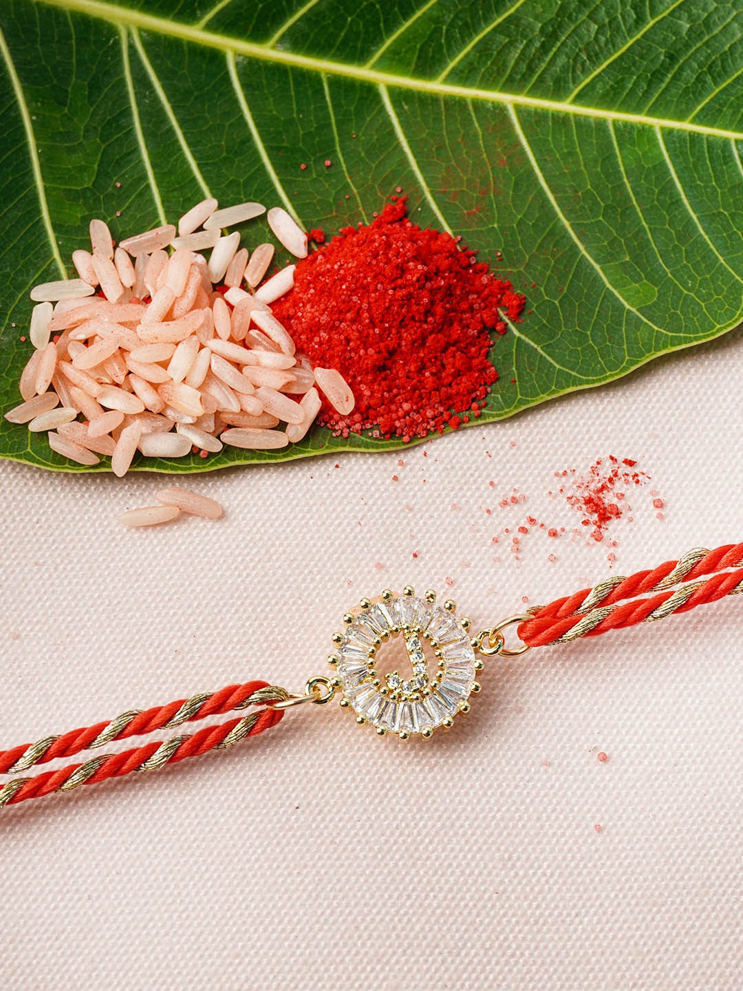

Ferosh Gold & Red Alphabet J Rhinestone Rakhi With Roli Chawal