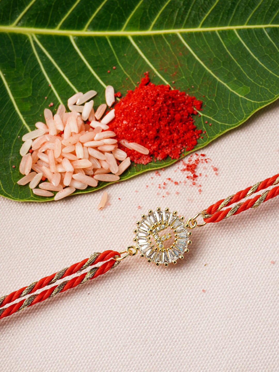 

Ferosh Red & Gold-Toned F Alphabet Rhinestone Studded Rakhi