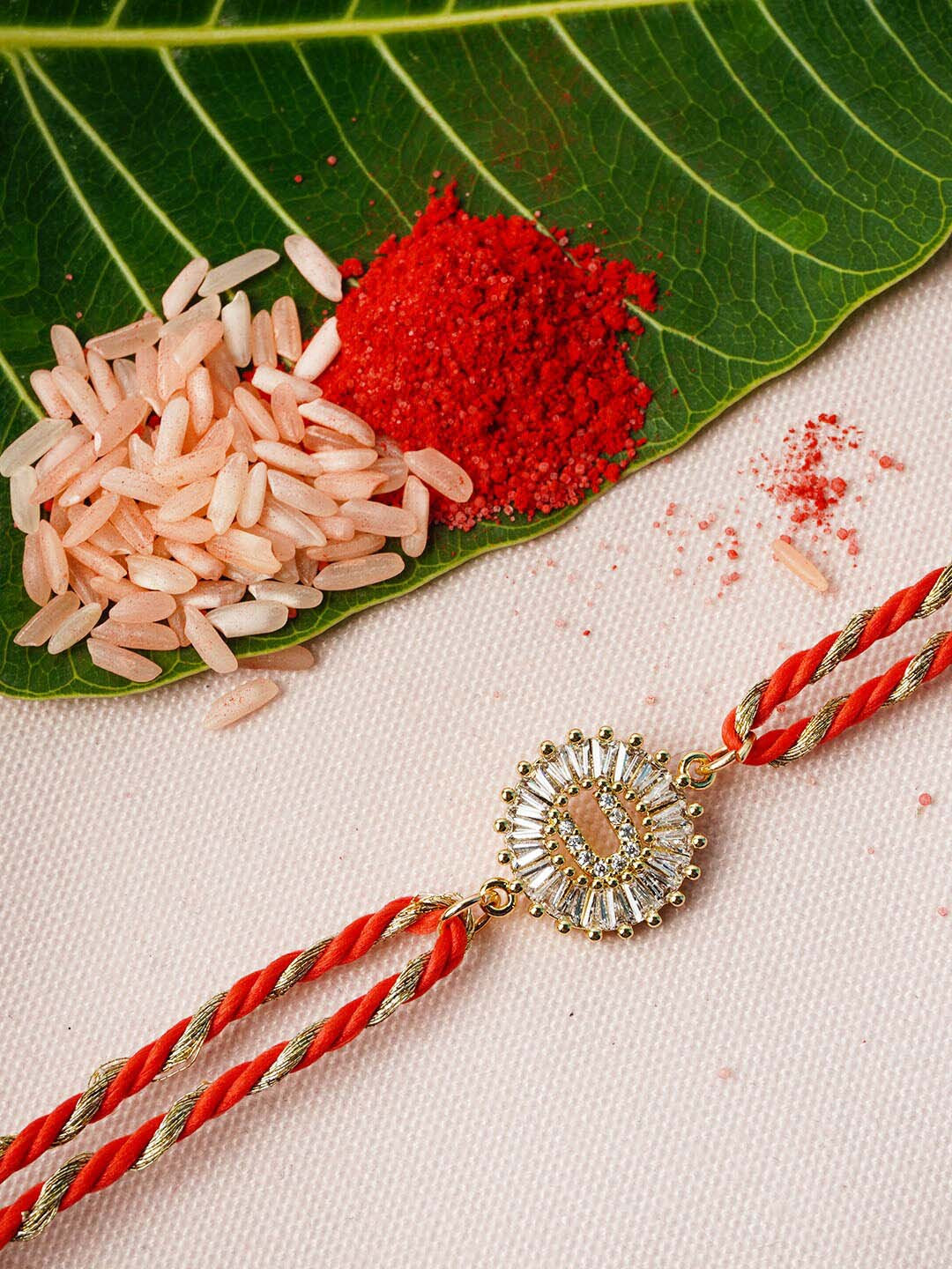 

Ferosh Adults-Unisex Gold Toned & Red U alphabet Studded Thread Rakhi